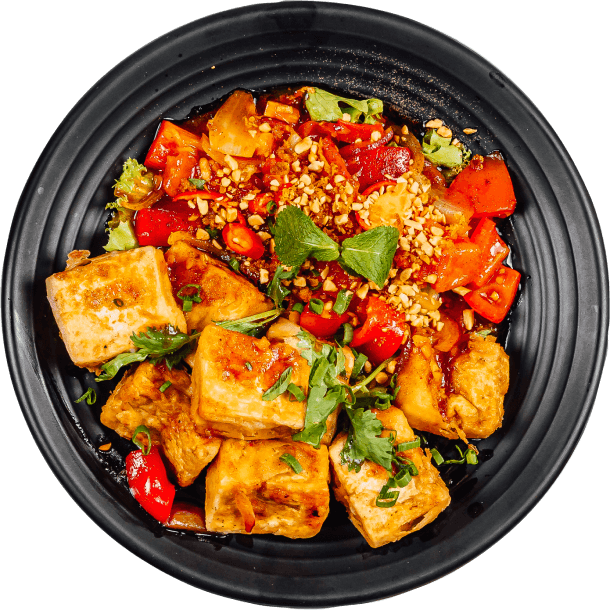 black dish full with fresh vegetables and bread